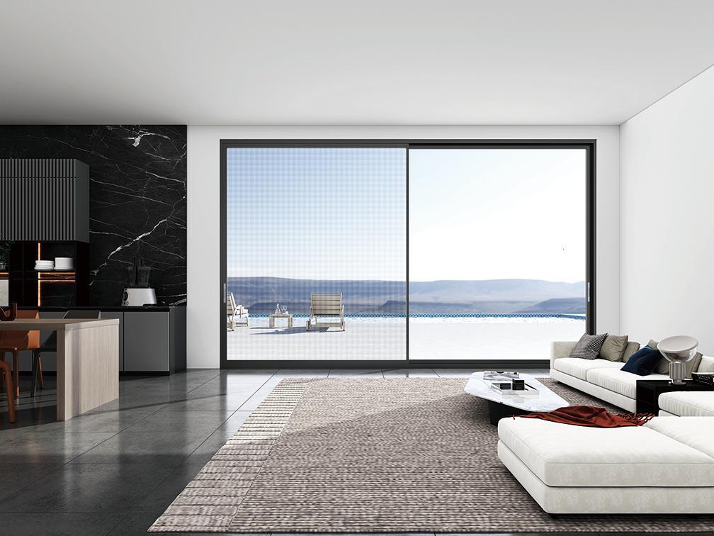 Living room framing a mountain view through full-height aluminium windows
